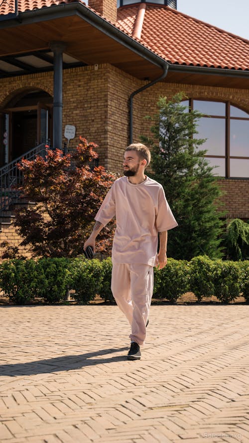 Man with Stubble Wearing Casual Clothing in front of House