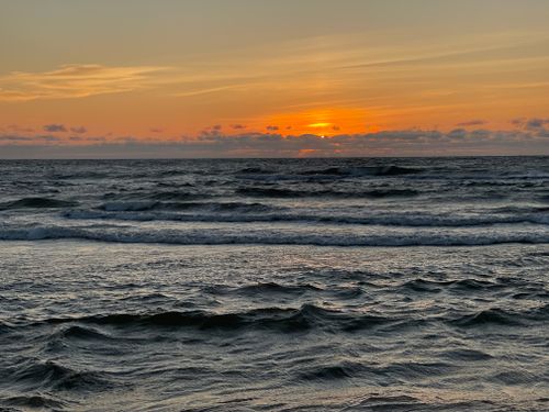 Free Breathtaking sunset over the Baltic Sea in Ventspils, Latvia, featuring vivid colors and gentle waves. Stock Photo