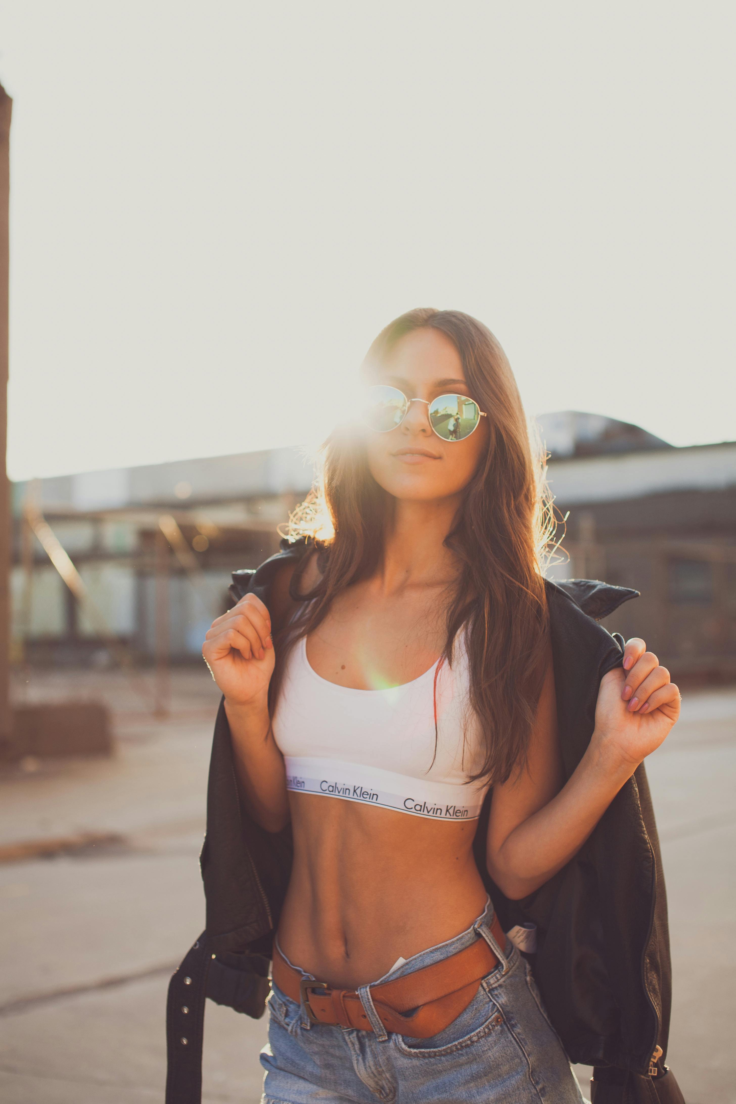 Woman wearing white Nike sports bra and brown and black plaid jacket photo  – Free Style Image on Unsplash
