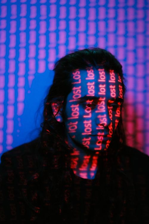 Free A moody, artistic image with bold colors projecting 'lost' on a person's face. Stock Photo