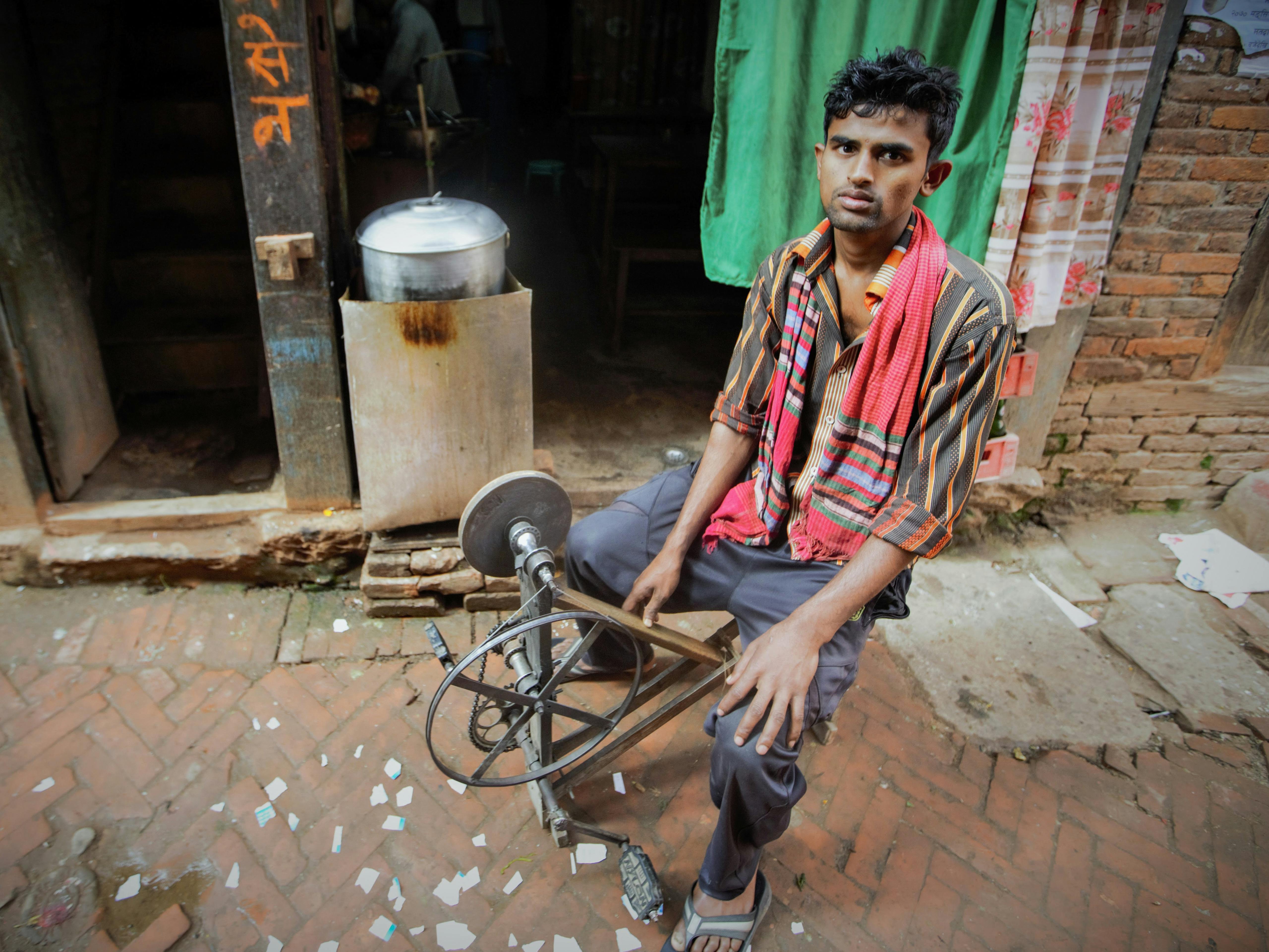 A Man Working with a Pedal Grinding Wheel · Free Stock Photo