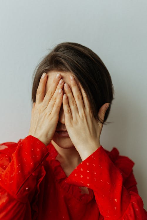 Woman Covering Face with Hands