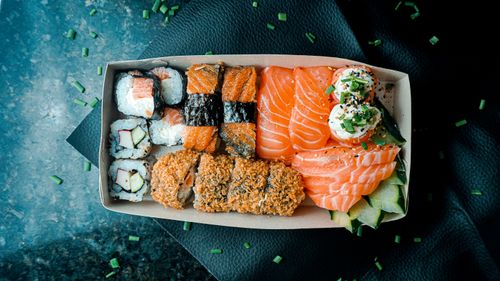 Free Delicious assortment of sushi with nigiri, maki, and sashimi beautifully presented. Stock Photo