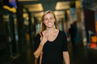 Woman in Black Scoop-neck Top Standing Indoor