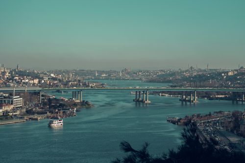 Free Explore a vibrant cityscape with bridges spanning a winding river under a clear sky. Stock Photo