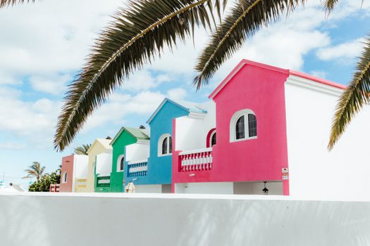 Pink and White Concrete House Beside Palm Tree