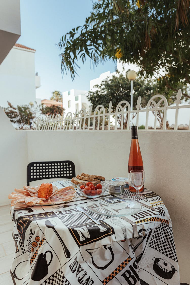 Lunch And Rose Wine On Balcony Of White Building