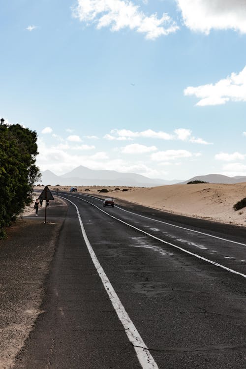 Black Asphalt Road Near a Desert Land
