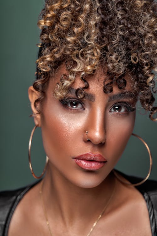 Close-up View of Curly Haired Woman with Earrings