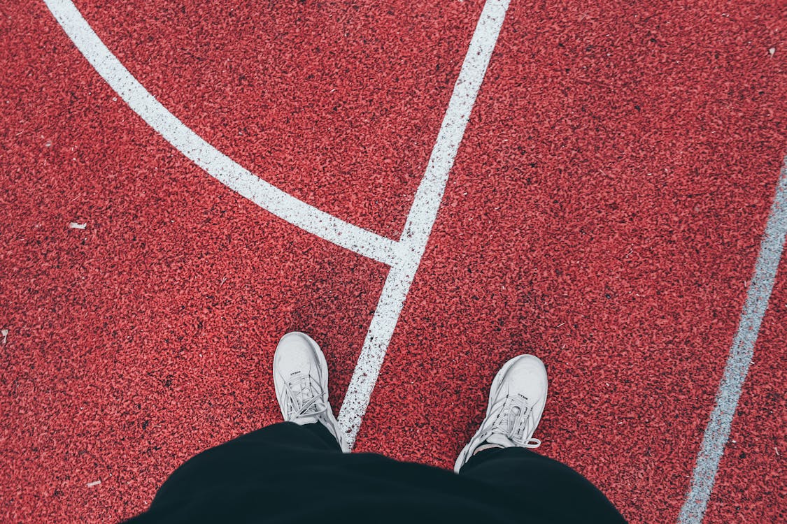 Person Standing on Athletics Track · Free Stock Photo