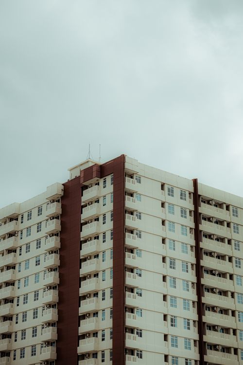 Free Vertical shot of a high-rise apartment building with a cloudy sky, showcasing modern architecture. Stock Photo
