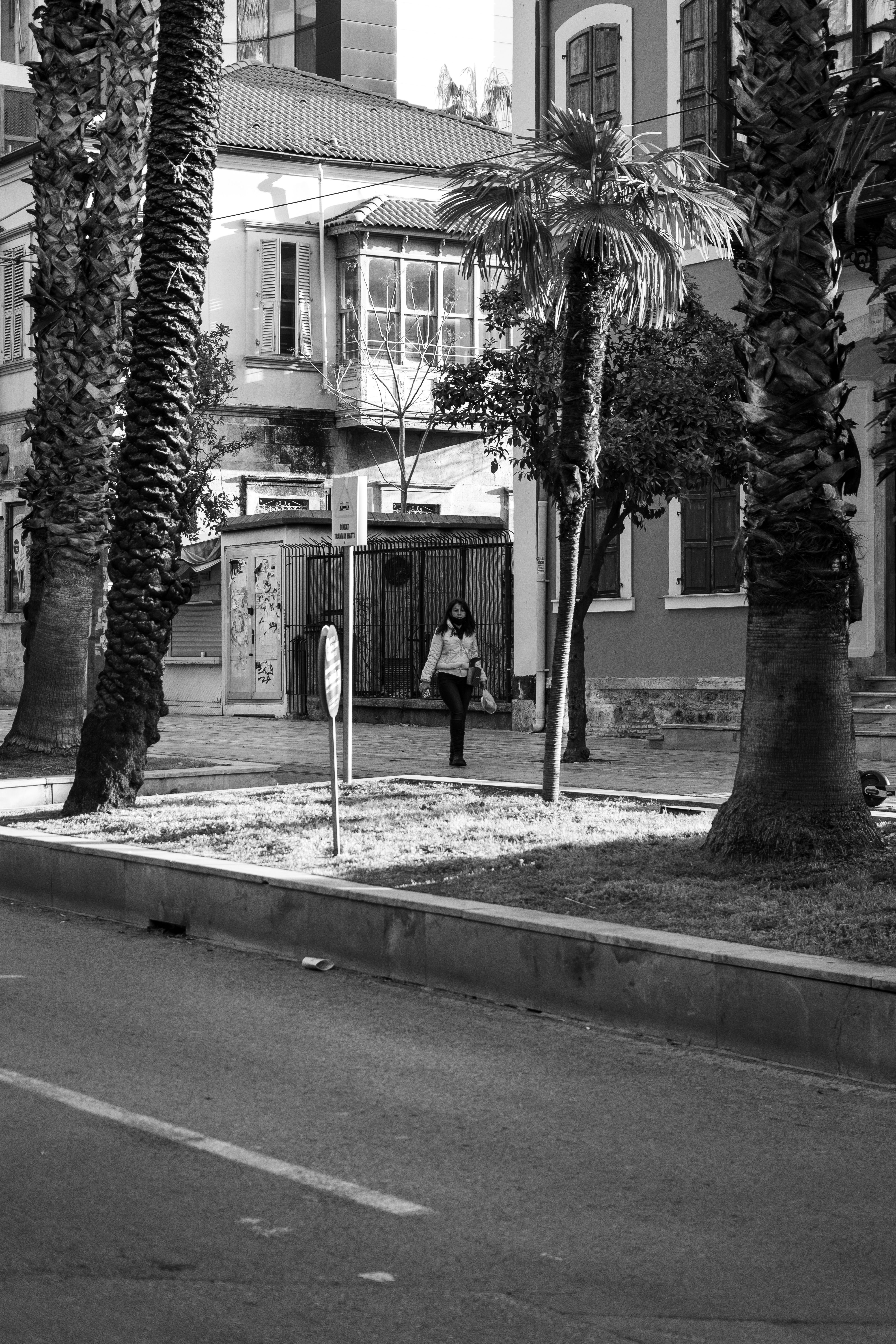 Grayscale Photo of Woman Walking on Sidewalk · Free Stock Photo