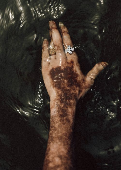 Free Intriguing close-up of a hand with rings submerged in dark water, offering a unique artistic perspective. Stock Photo