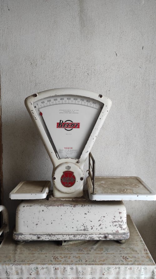White and Red Analog Weighing Scale