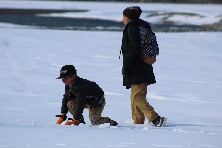 Children Walking In Snow