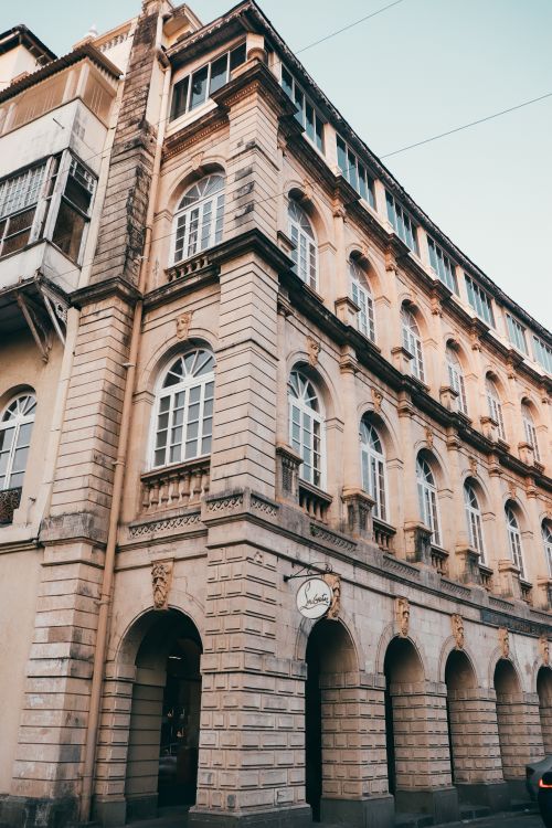Free A vintage architectural masterpiece, showcasing elegant arches and detailed facades, captured during daylight. Stock Photo