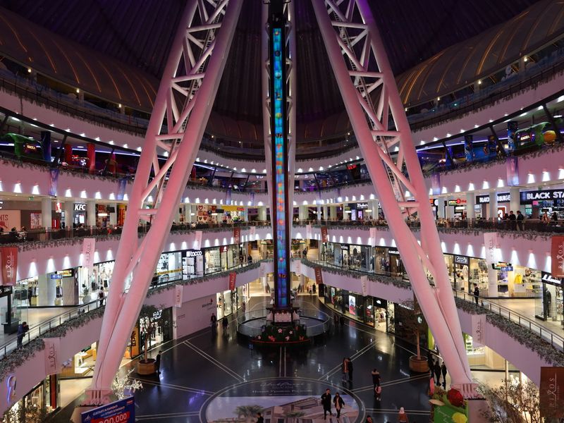 Shoppers walking inside a busy modern shopping mall