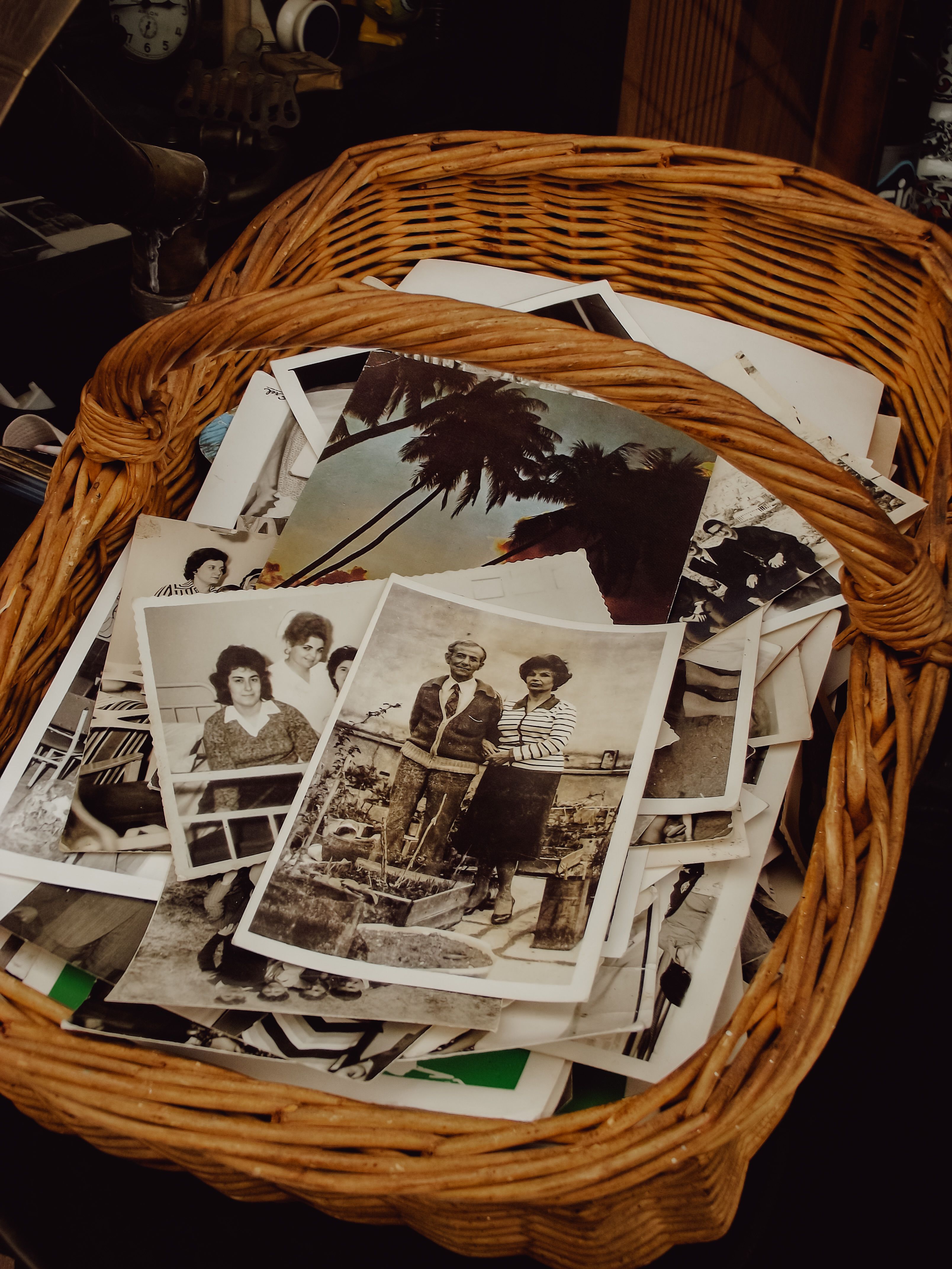 A basket filled with vintage black and white photographs, evoking nostalgia.