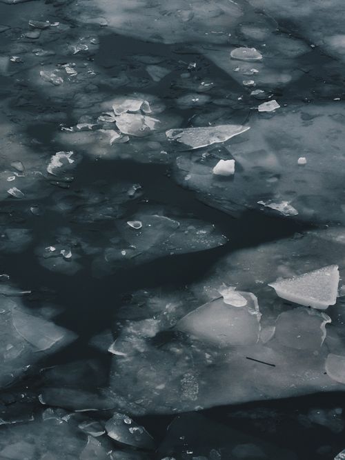 Free Close-up of floating ice pieces on a dark water surface, evoking a cold winter ambiance. Stock Photo
