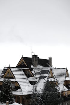 A cozy wooden house in winter surrounded by snow in Bukowina Tatrzańska, Poland.