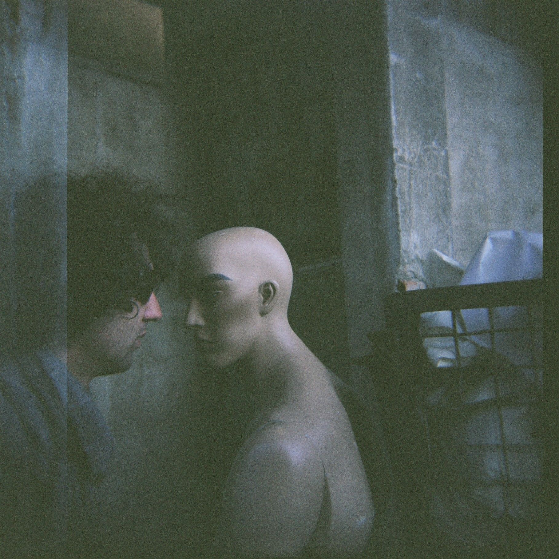 A Man Looking at A Mannequin