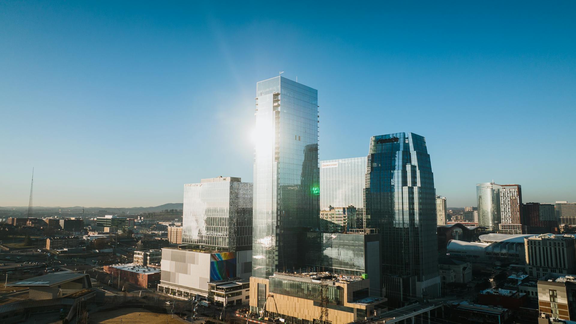 Aerial view of Nashville's modern skyscrapers under a clear blue sky.