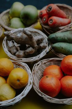 A vibrant collection of fruits and vegetables displayed in wicker baskets.