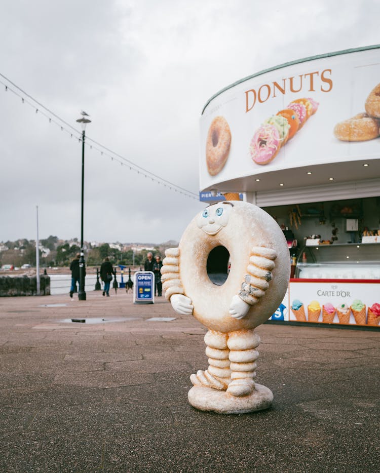 Figure In Front Of Donuts Store