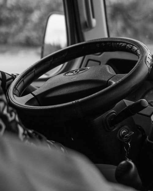 Grayscale Photo of a Steering Wheel
