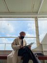 Man in White Dress Shirt Holding Newspaper