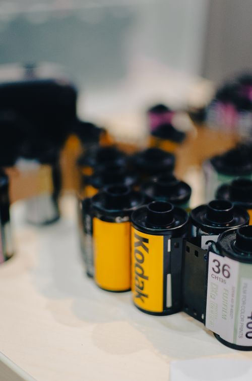 Free A selection of Kodak film rolls showcasing various types on a table, perfect for analog photography enthusiasts. Stock Photo