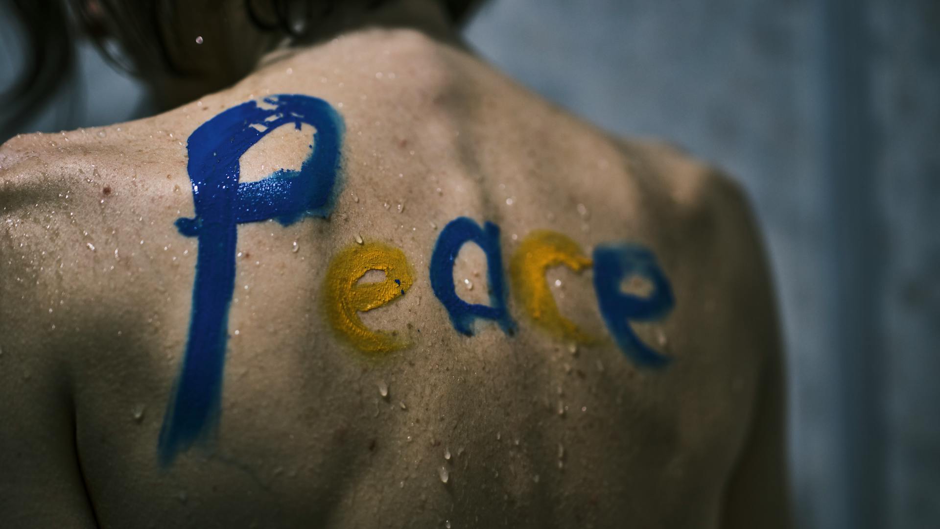 Close-up Photo of Person's Back with a Word written