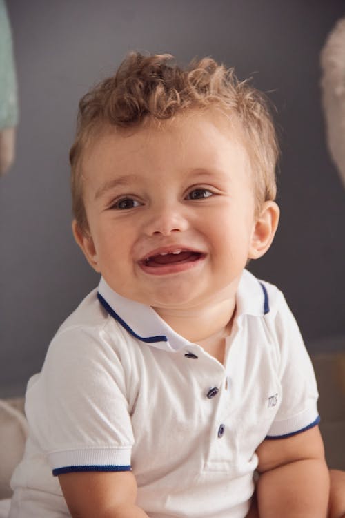 Little Boy in White Polo Shirt Smiling