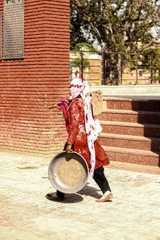 Farmer Carrying a Shovel and Basin