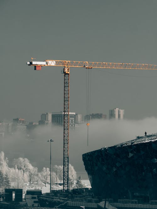Photo of a Tower Crane Under Gray Sky