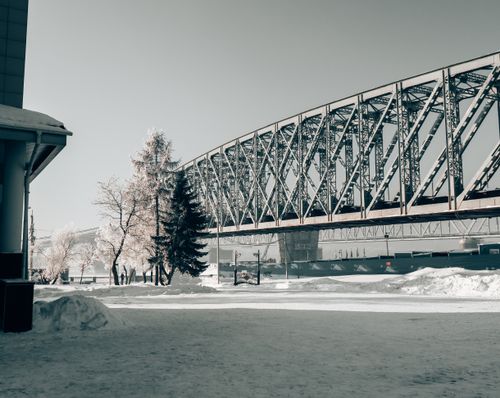 Free A snowy urban landscape featuring a railway bridge in Novosibirsk, Russia. Stock Photo