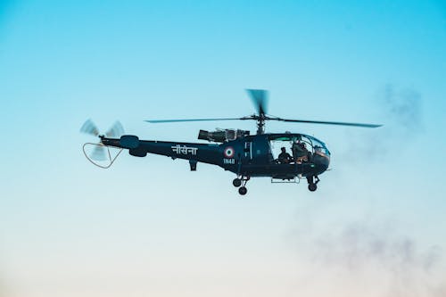 Indian Navy Helicopter Flying Under Blue Sky