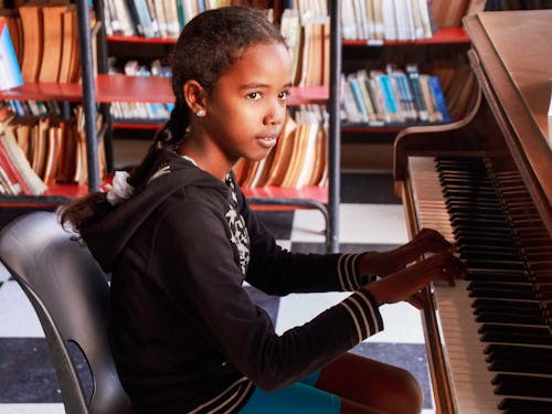 Young Girl Playing a Piano