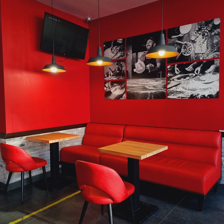 A Red Couch Near the Wooden Tables