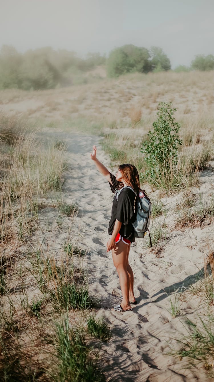 Girl Walking On Beach Protecting Eyes From Sun