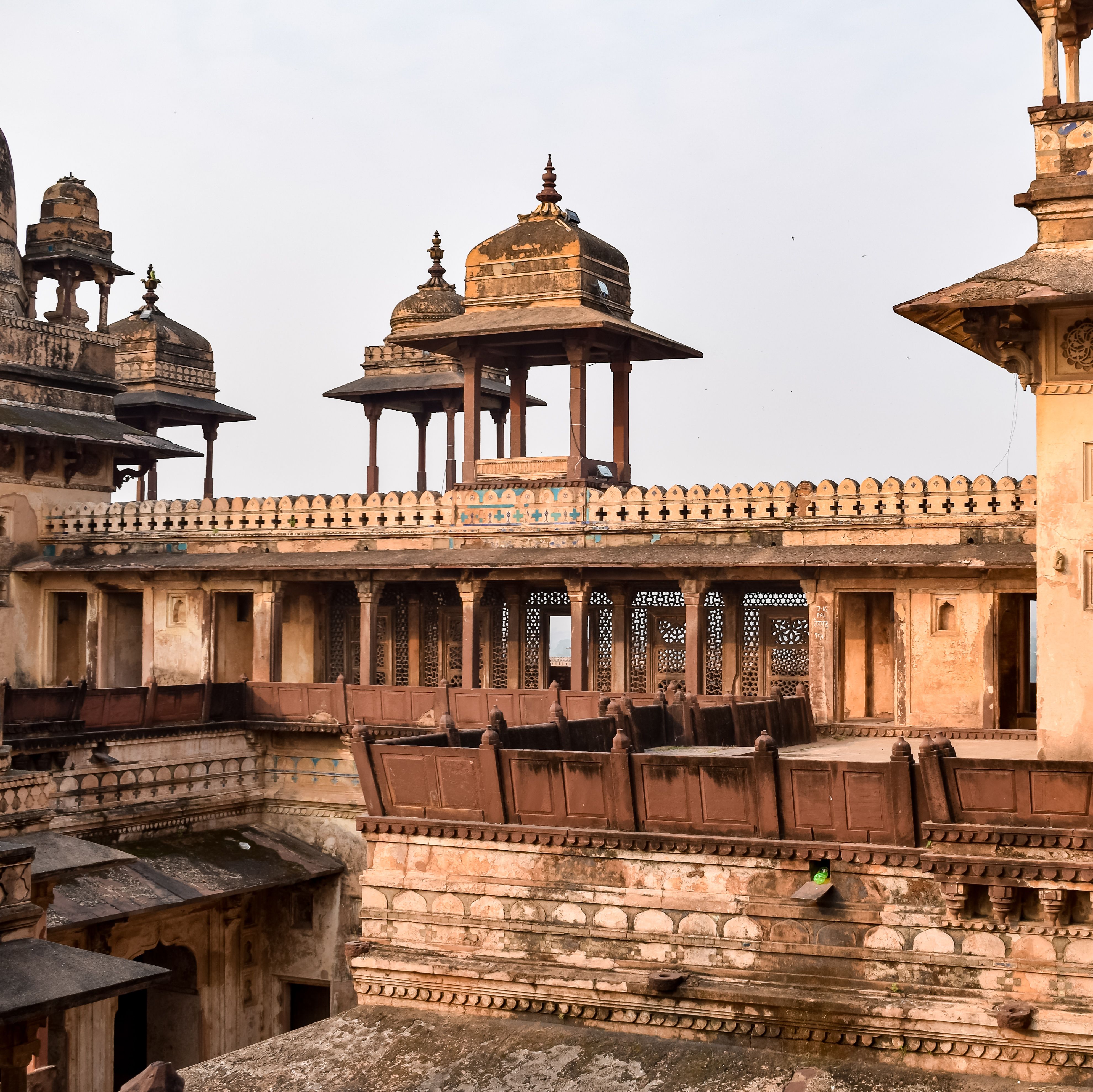 Sandstone ramparts of a hilltop fort palace at sunset