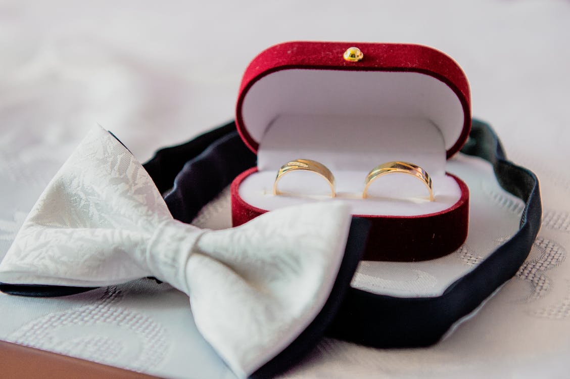 Free Wedding Bands in a Jewelry Box Near a Bow Tie Stock Photo