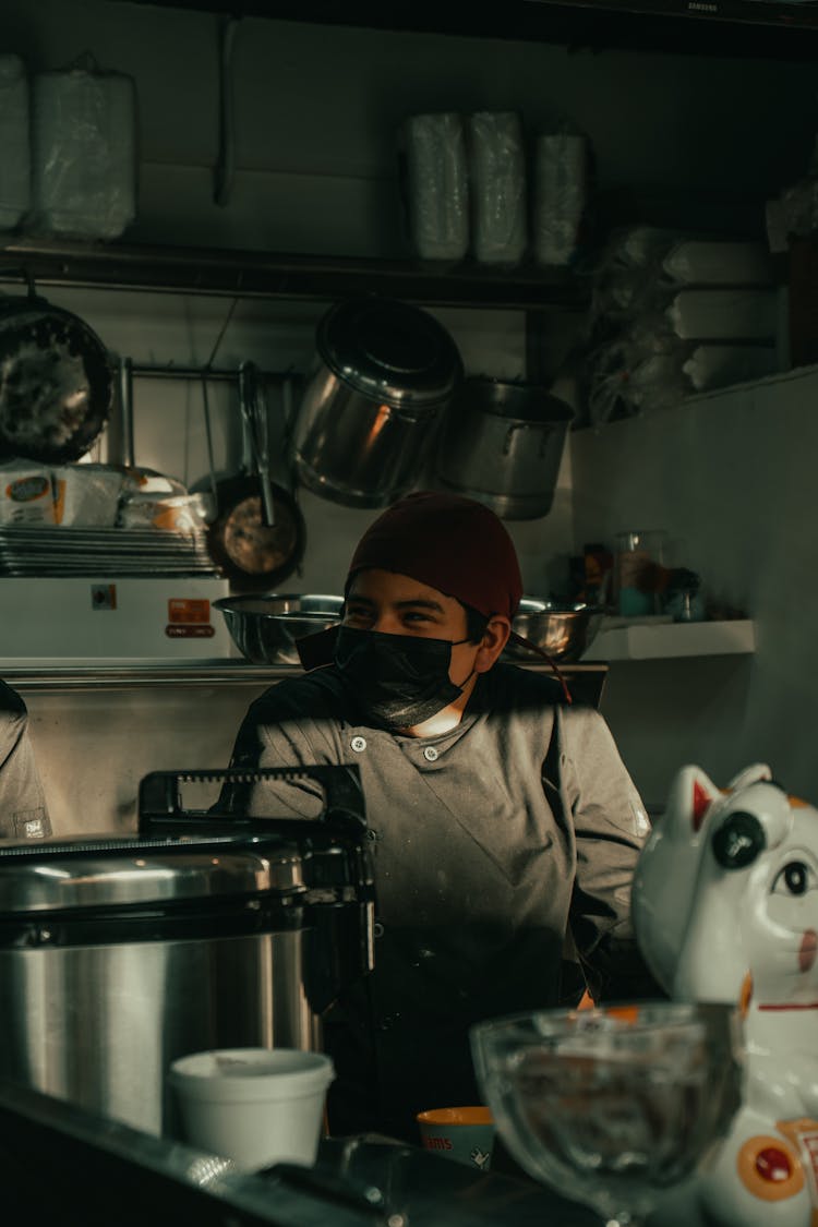 Woman In Mask In Kitchen