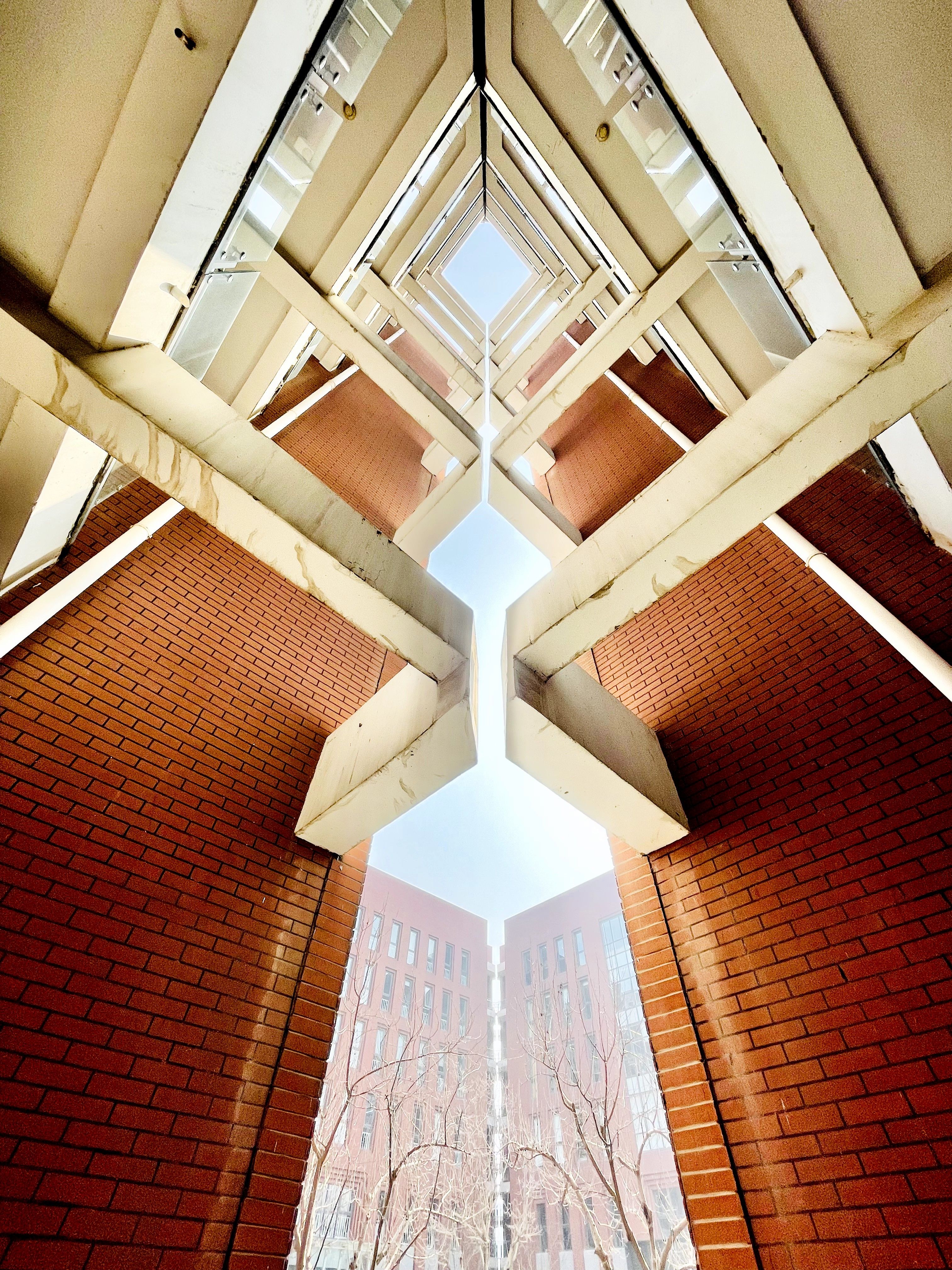 Dynamic low-angle view of modern architecture showcasing geometric patterns in Beijing, China.