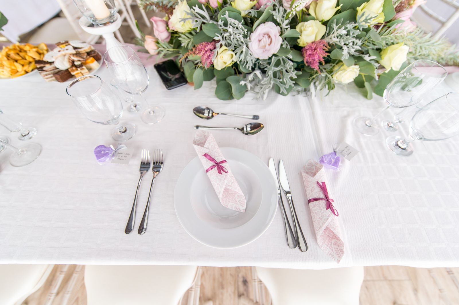 A table setting with a floral centerpiece and ordinary tableware.