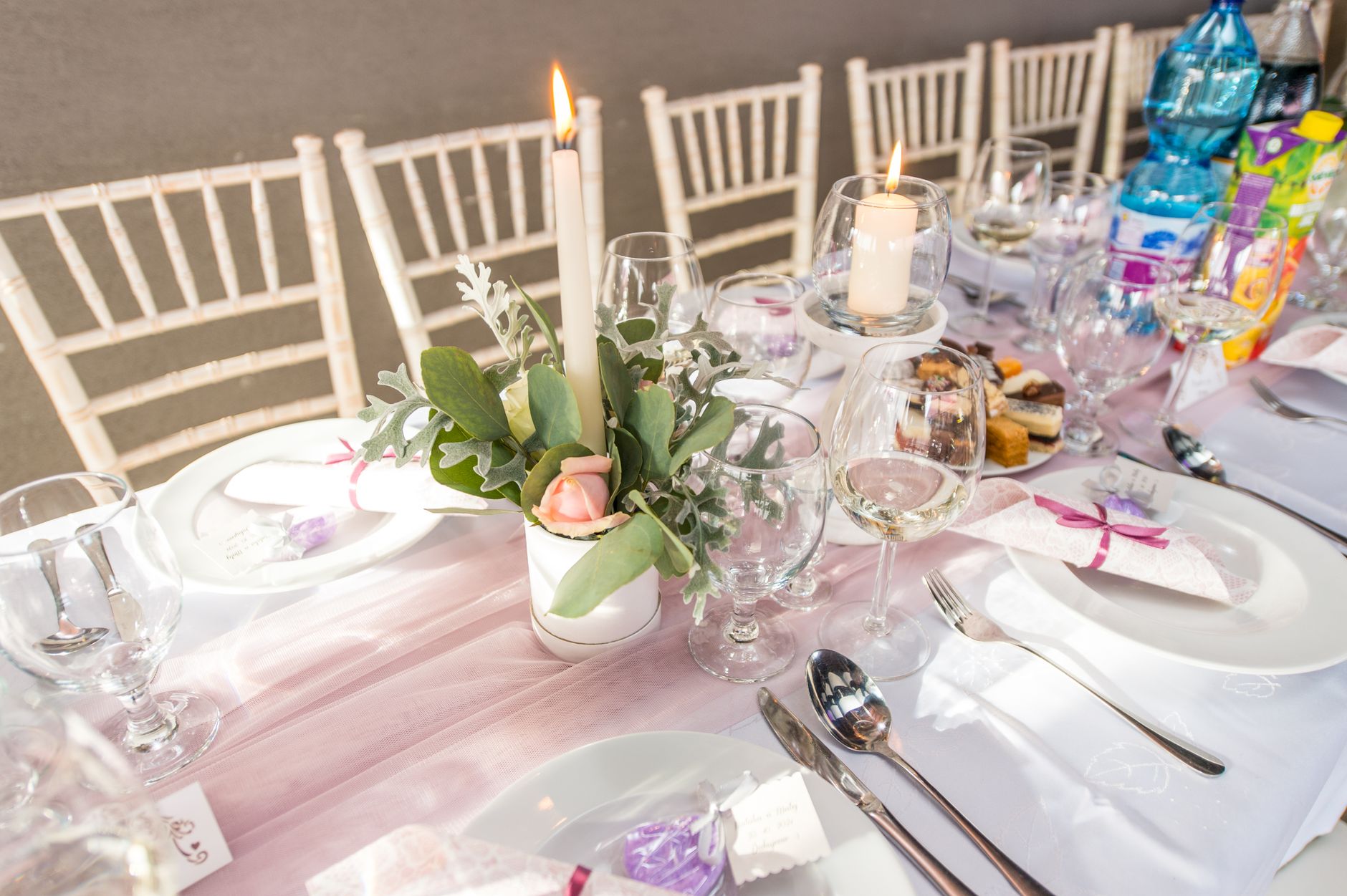 Beautifully arranged dining table for an elegant occasion with floral centerpiece and candles.