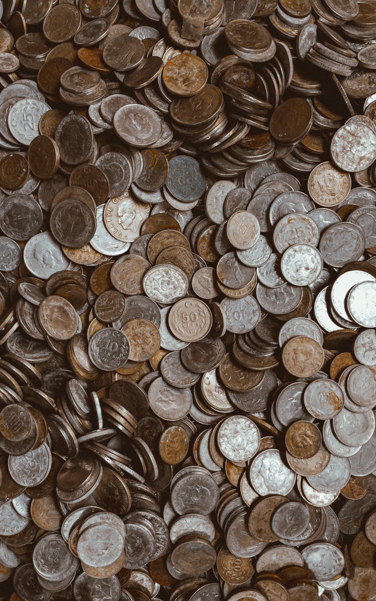 Silver And Gold Round Coins In Close-up Photography