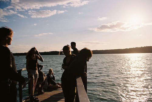 People on the Wooden Dock During Sunset