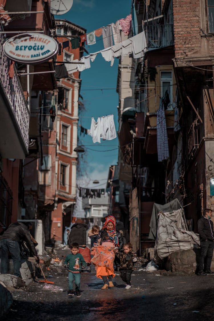 Mother With Kids On Messy Street