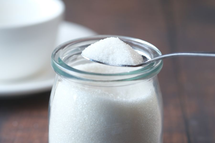 White Sugar in Glass Jar with Spoon